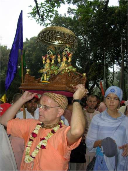 Mahavishnu Swami carrying a small deity altar on his head in a festival procession